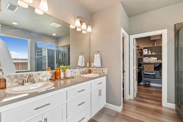 bathroom featuring vanity, a shower with shower door, and hardwood / wood-style floors