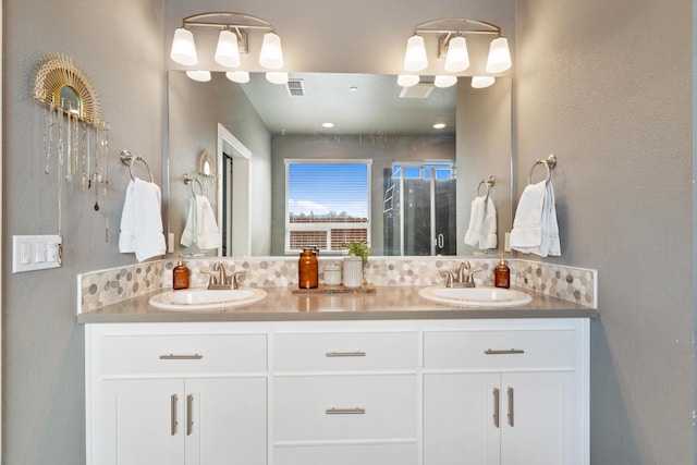 bathroom with vanity and a shower with shower door