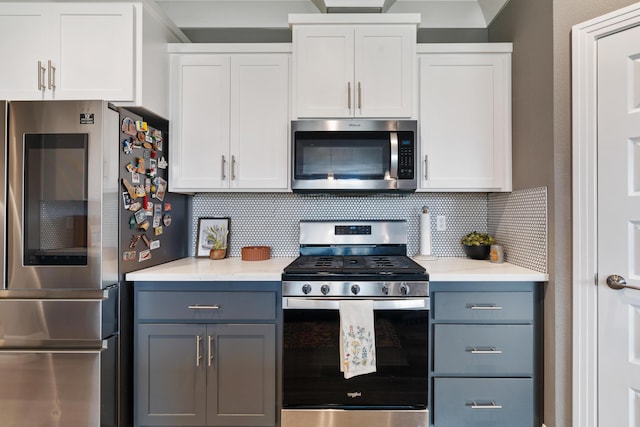 kitchen featuring stainless steel appliances, gray cabinets, white cabinets, and backsplash