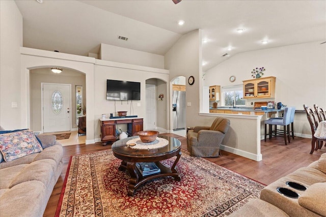 living room featuring hardwood / wood-style floors and high vaulted ceiling