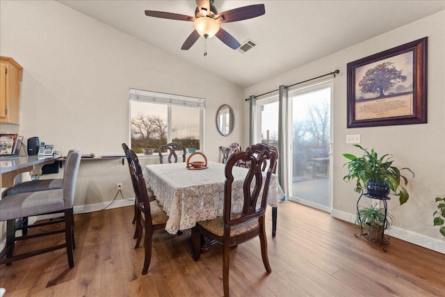 dining space with lofted ceiling, hardwood / wood-style floors, a wealth of natural light, and ceiling fan