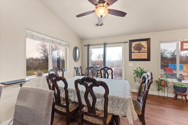 dining area with wood-type flooring, lofted ceiling, and ceiling fan