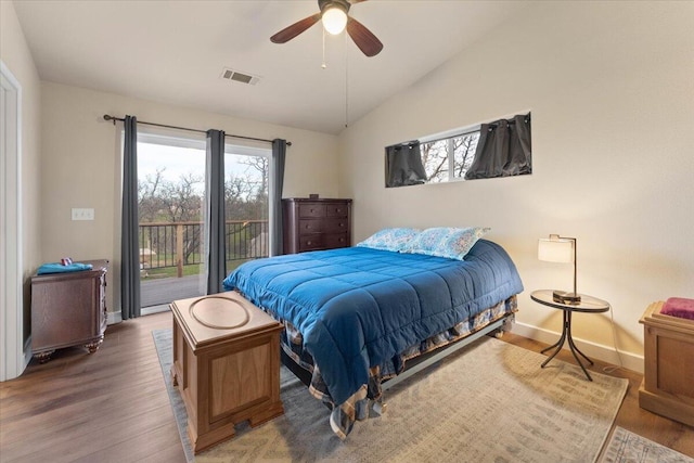 bedroom with ceiling fan, lofted ceiling, access to exterior, and dark hardwood / wood-style flooring