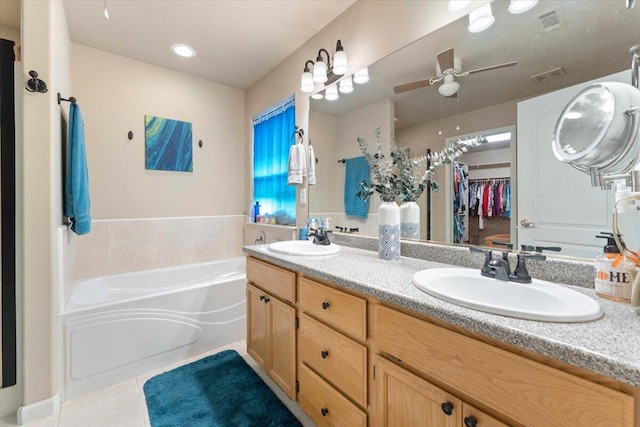 bathroom with tile patterned flooring, vanity, a washtub, and ceiling fan