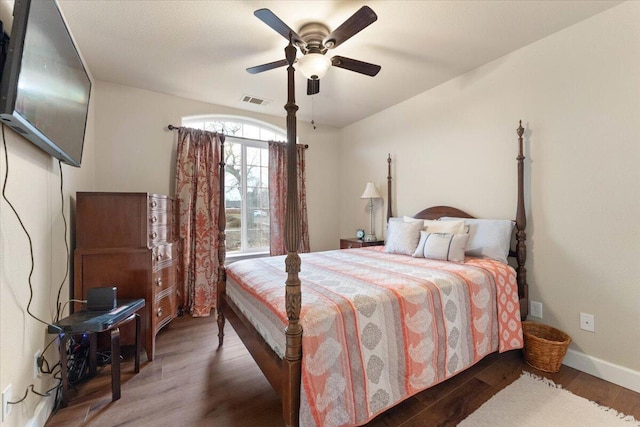 bedroom with ceiling fan and dark hardwood / wood-style floors