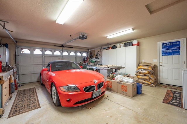 garage with a garage door opener and water heater