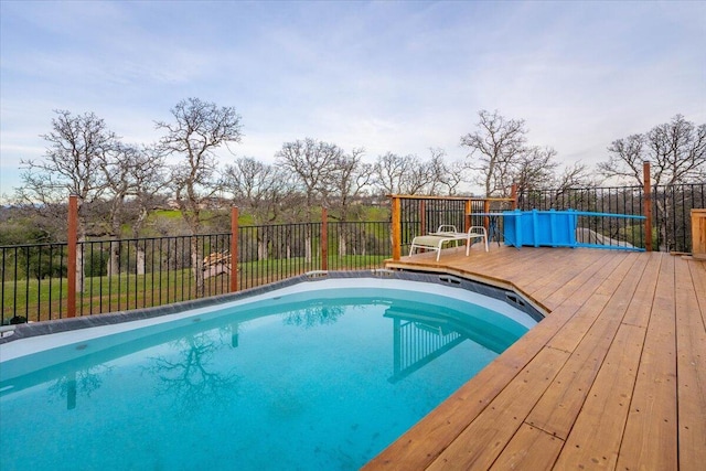 view of swimming pool featuring a wooden deck