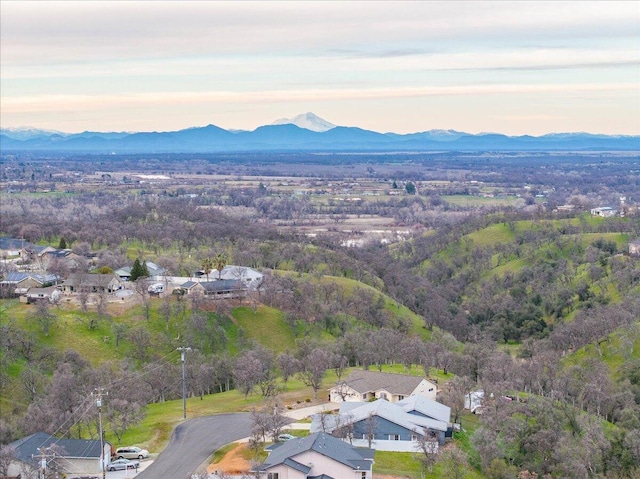 aerial view at dusk featuring a mountain view