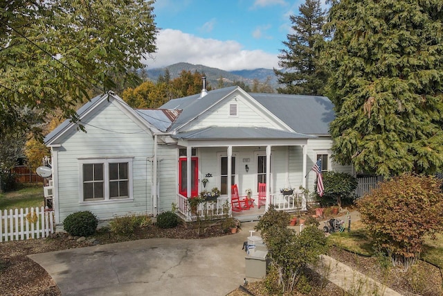 view of front of home with a porch and a mountain view