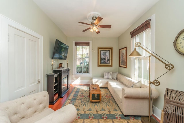 living room with hardwood / wood-style floors and ceiling fan