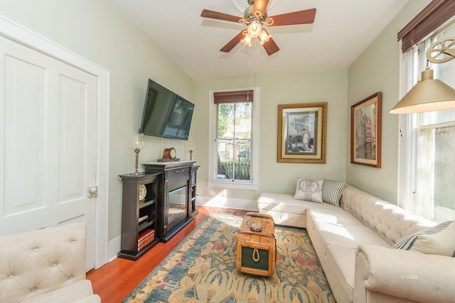 living room with ceiling fan and light wood-type flooring