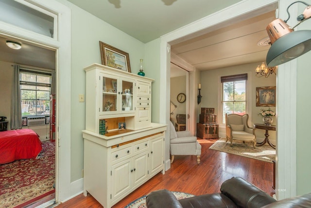 sitting room with dark hardwood / wood-style floors and a chandelier