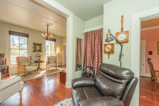 living room featuring wood-type flooring and a notable chandelier