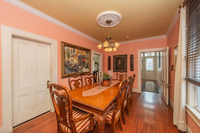 dining room featuring an inviting chandelier, wood-type flooring, and ornamental molding