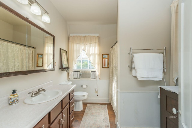 bathroom with vanity, cooling unit, hardwood / wood-style floors, and toilet