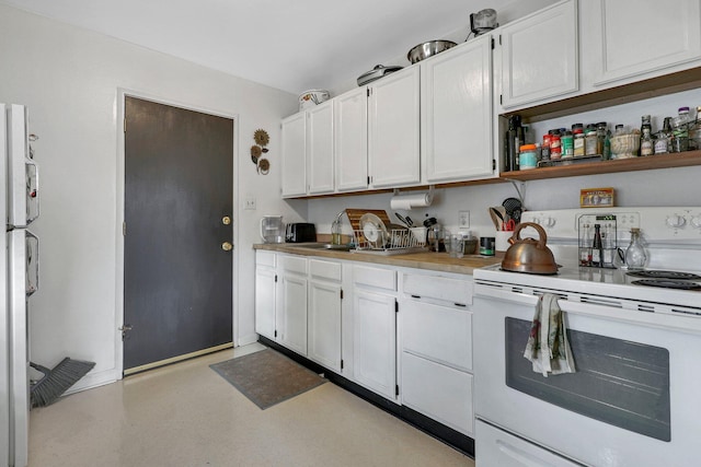 kitchen with sink, white electric range, fridge, and white cabinets