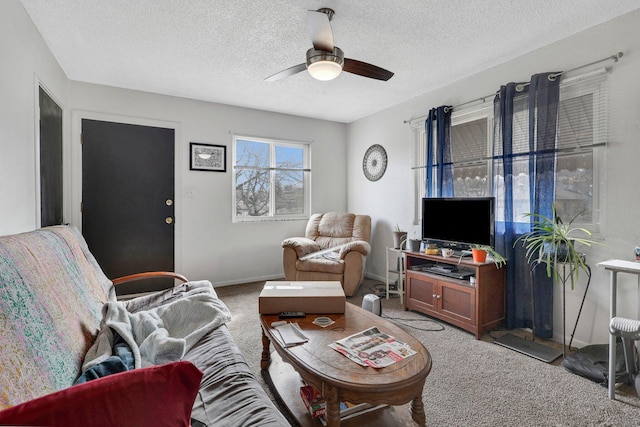 living room featuring a textured ceiling, ceiling fan, and carpet flooring