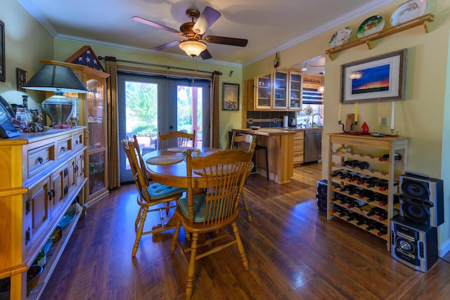 dining space featuring dark wood-type flooring, ornamental molding, french doors, and ceiling fan