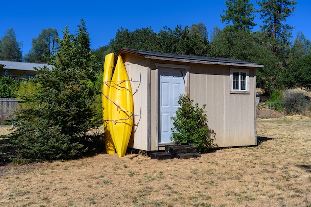 view of outdoor structure featuring a lawn