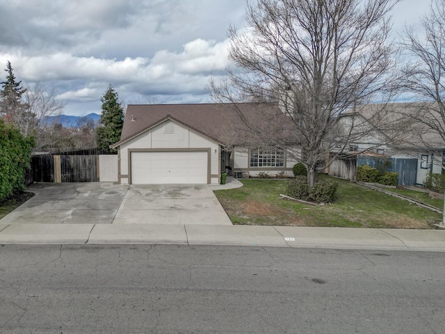 single story home featuring a garage, a mountain view, and a front yard