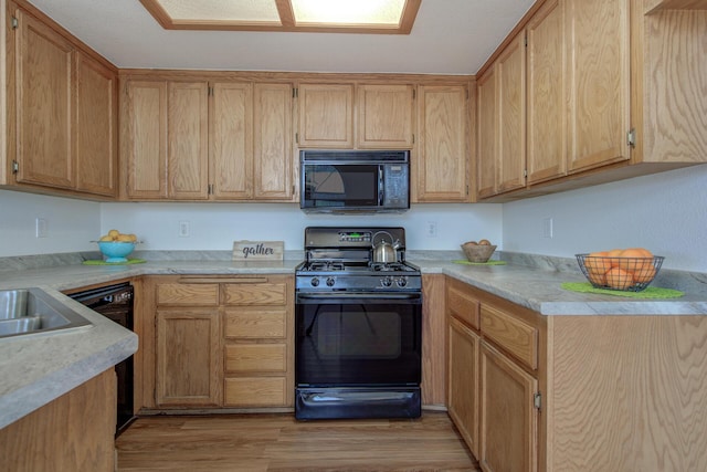 kitchen with black appliances and light wood-type flooring