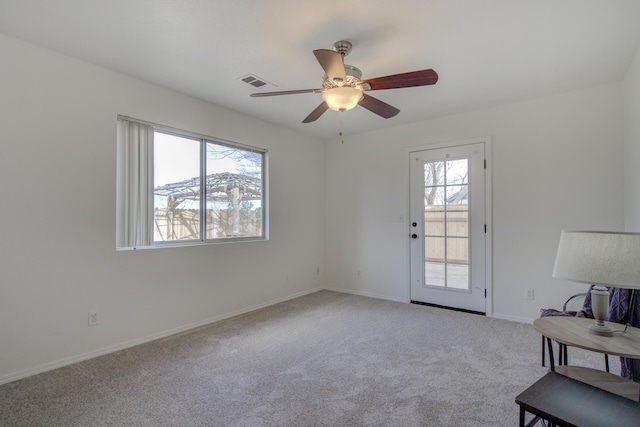 unfurnished room featuring light colored carpet and ceiling fan