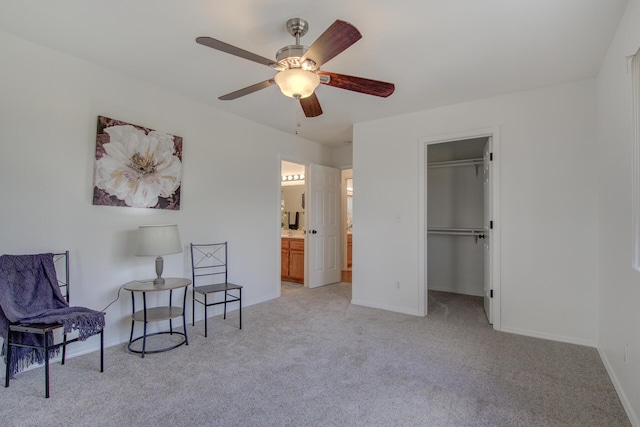 living area with light colored carpet and ceiling fan