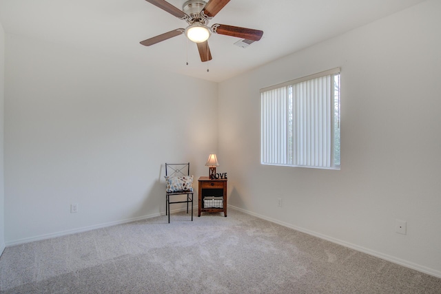 carpeted spare room featuring ceiling fan