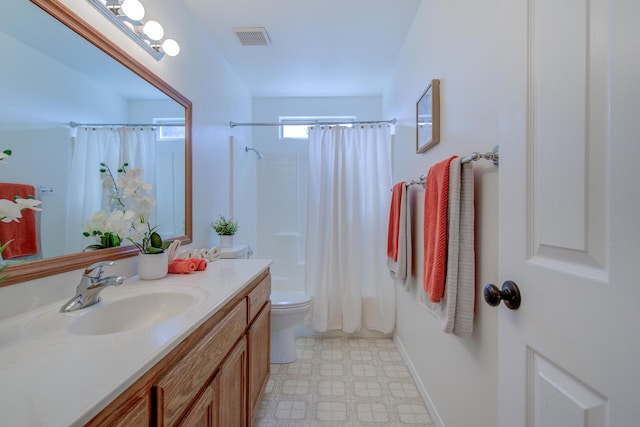 full bathroom featuring shower / bath combination with curtain, vanity, and toilet