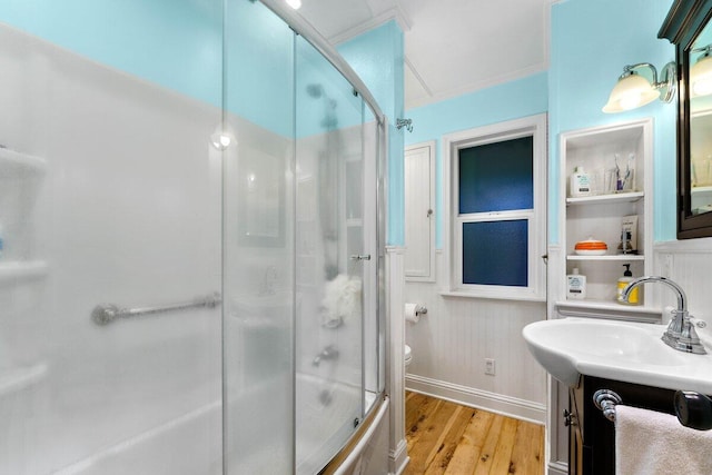 bathroom featuring ornamental molding, wood-type flooring, toilet, and vanity