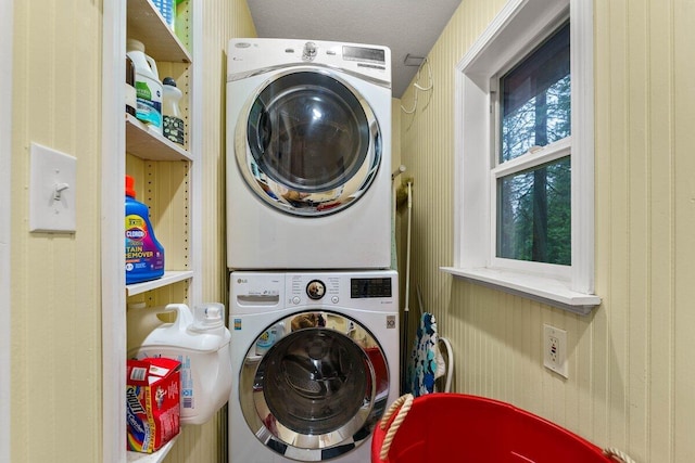 laundry room with stacked washing maching and dryer