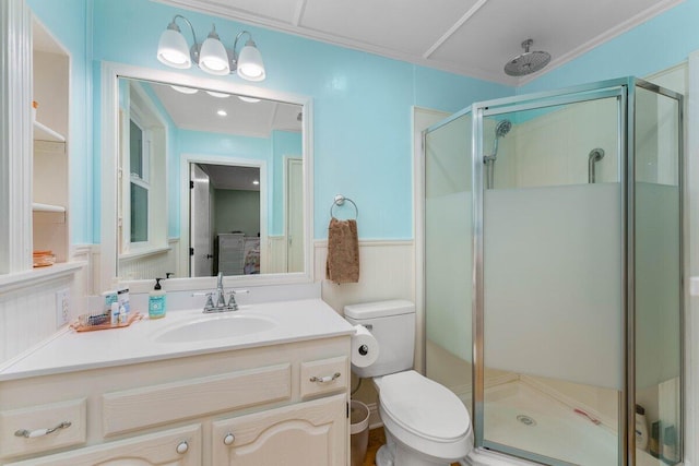 bathroom with vanity, a shower with door, and toilet