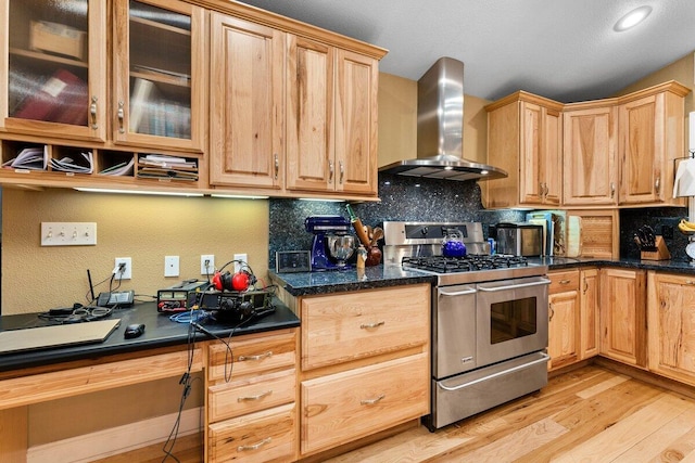 kitchen with double oven range, light hardwood / wood-style flooring, decorative backsplash, and wall chimney range hood