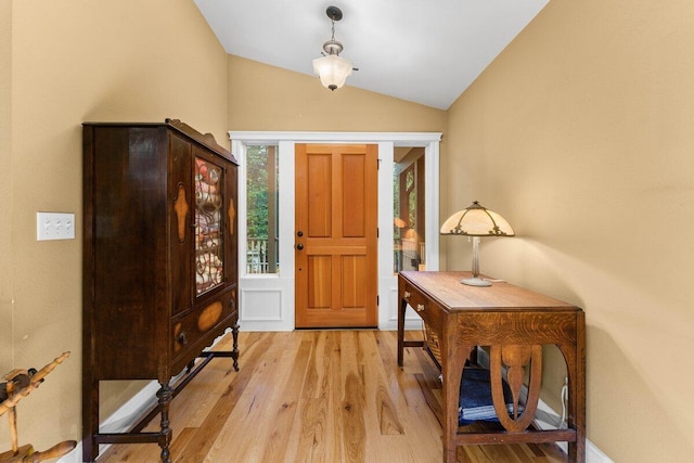 entryway with vaulted ceiling and light wood-type flooring