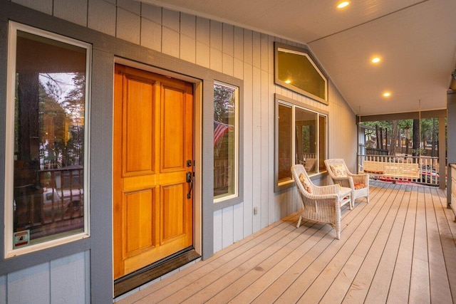 view of exterior entry featuring covered porch