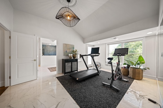 workout room featuring high vaulted ceiling