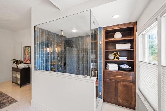 bathroom featuring a shower with shower door