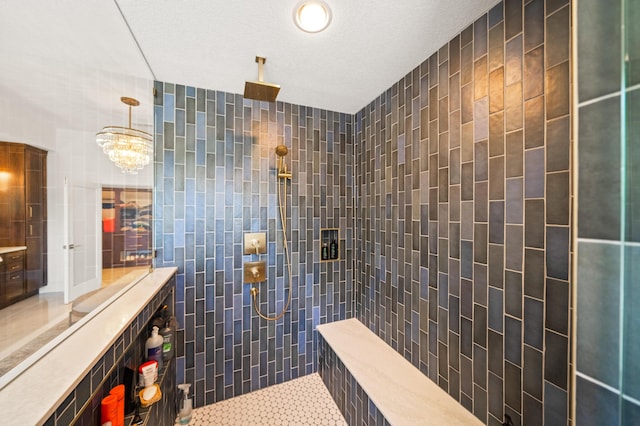 bathroom with tile patterned floors, a textured ceiling, tile walls, and a tile shower