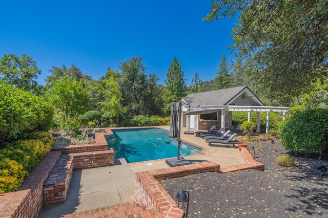 view of pool featuring a patio and an outdoor structure