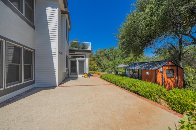 view of patio / terrace with a shed