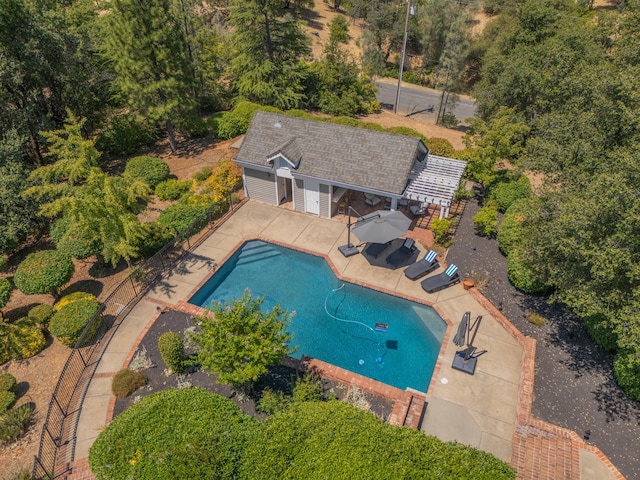 view of swimming pool with a patio and an outbuilding