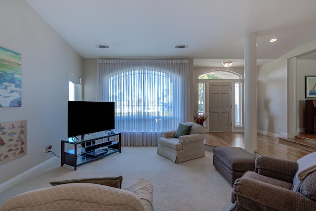 living room featuring recessed lighting, visible vents, light carpet, and baseboards