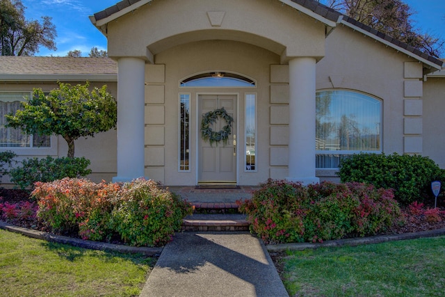 entrance to property featuring stucco siding