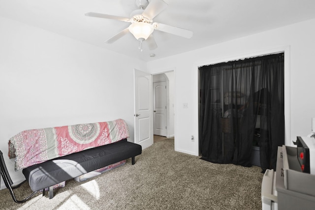 interior space featuring a ceiling fan, baseboards, and carpet floors