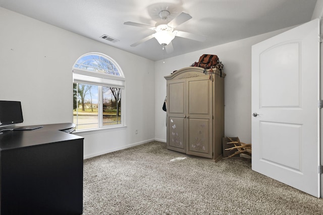 unfurnished office with visible vents, light carpet, baseboards, and a ceiling fan