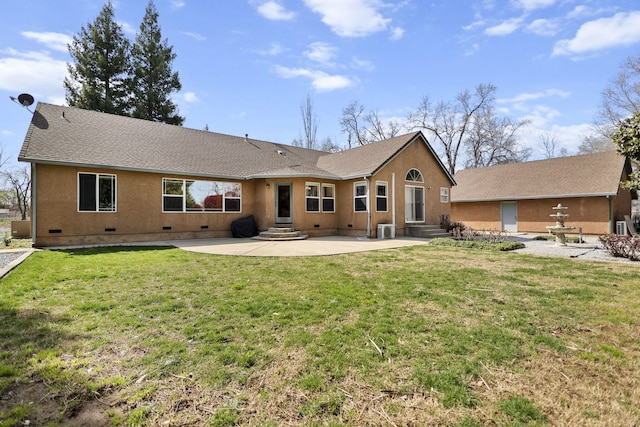back of property with entry steps, a patio area, a lawn, and crawl space