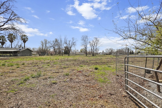 view of yard featuring a rural view and fence