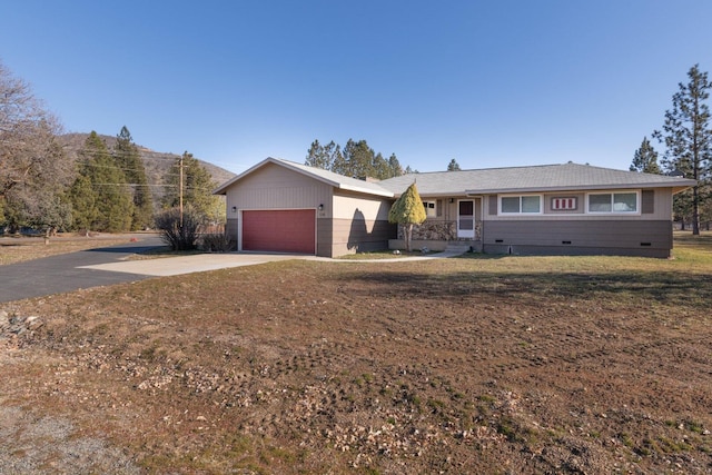 single story home featuring a garage and a front lawn