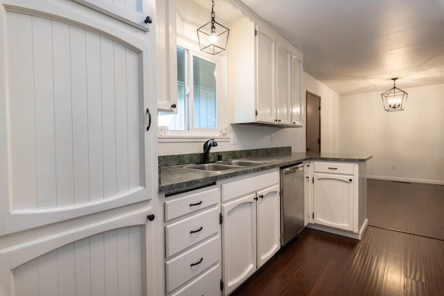 kitchen featuring pendant lighting, stainless steel dishwasher, sink, and white cabinets