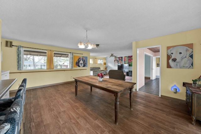 dining area featuring an inviting chandelier and dark hardwood / wood-style flooring